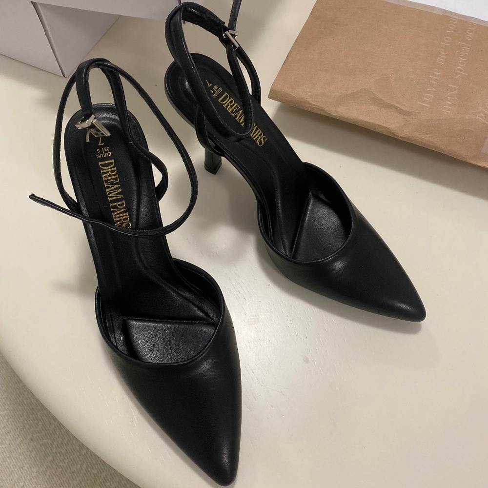 Black pointed toe heels with strap